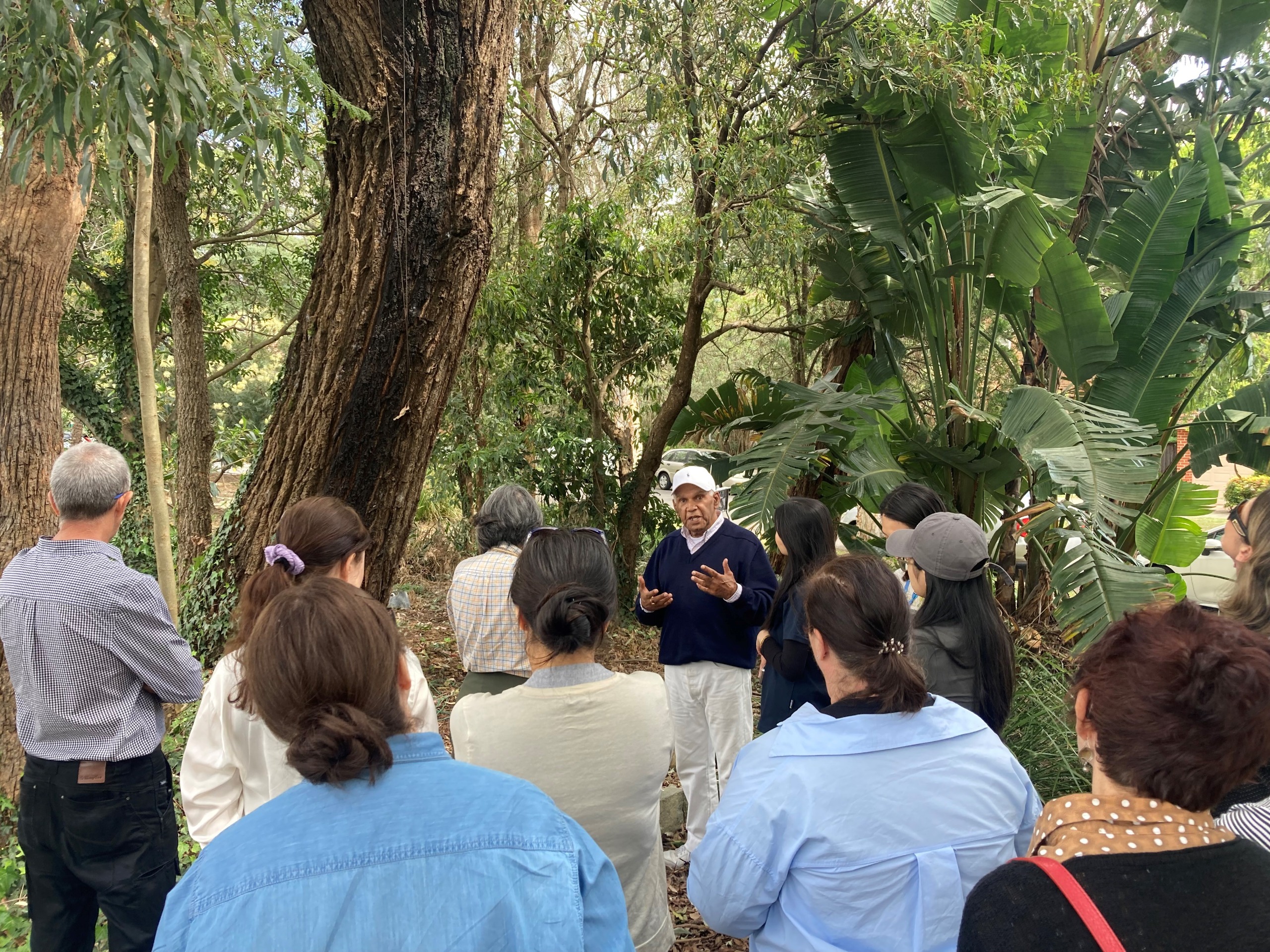 A group of teachers outside being presented on cultural environmental significance by Uncle Jimmy Smith