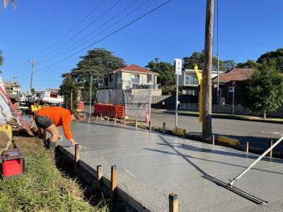 Woman smoothing new cement with small trowel
