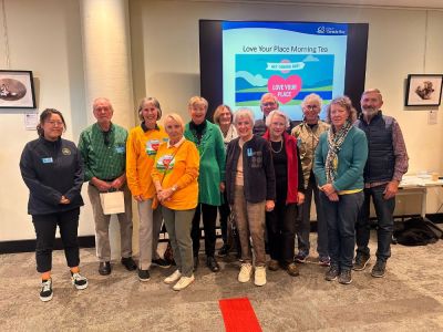 Group of volunteers standing in front of a screen
