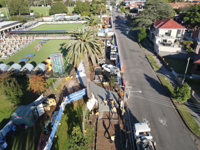 Aerial of construction crew laying pavement.